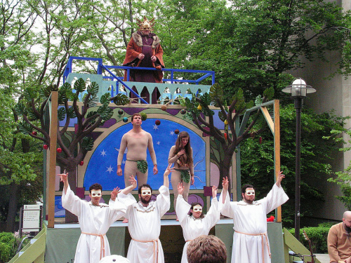 The performance of the Chester Fall of Man by Purdue University’s MARS players. Note how the four angels appear at ground level, Adam and Eve on the first level of the wagon, and God on the scaffold at the rear of the wagon.